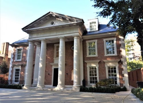 Huxley House, a stunning neoclassical property featuring a brick facade, white columns, and a portico, showcasing a recent timber installation project.